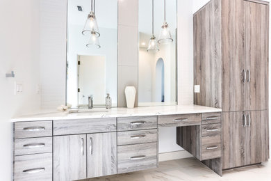 Example of a large minimalist white tile and porcelain tile single-sink bathroom design in Other with flat-panel cabinets, an undermount sink, quartz countertops and a built-in vanity