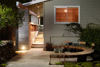 This is an example of a mid-sized modern backyard patio in San Francisco with concrete pavers.