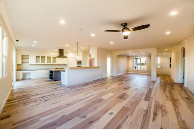 Inspiration for a large transitional open concept medium tone wood floor family room remodel in Sacramento with beige walls