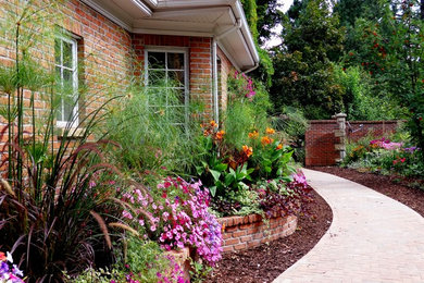 Inspiration for a large traditional partial sun backyard brick landscaping in Salt Lake City for summer.
