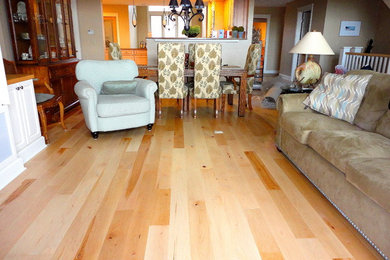 Inspiration for a mid-sized rustic open concept light wood floor living room remodel in Other with beige walls and no fireplace