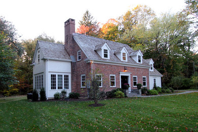 Inspiration for a large timeless multicolored two-story mixed siding gable roof remodel in New York
