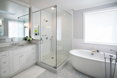 Inspiration for a large contemporary master gray tile and subway tile marble floor and gray floor bathroom remodel in St Louis with white cabinets, a two-piece toilet, gray walls, an undermount sink, marble countertops, a hinged shower door, gray countertops and shaker cabinets