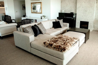 Inspiration for a mid-sized modern open concept living room in Auckland with carpet, a standard fireplace, a stone fireplace surround and beige floor.