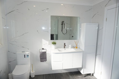 Large contemporary master bathroom in Sydney with an open shower and marble.