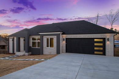 Large transitional beige one-story brick house exterior idea in Little Rock with a hip roof and a shingle roof