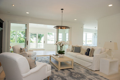Mid-sized beach style formal and open concept light wood floor living room photo in New York with white walls, no tv, a standard fireplace and a metal fireplace
