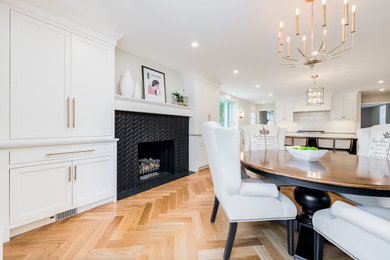 Eat-in kitchen - large contemporary u-shaped light wood floor and brown floor eat-in kitchen idea in Philadelphia with an undermount sink, beaded inset cabinets, white cabinets, quartzite countertops, white backsplash, cement tile backsplash, stainless steel appliances, an island and white countertops