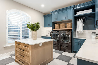 Example of a large transitional l-shaped porcelain tile and multicolored floor dedicated laundry room design in Salt Lake City with an undermount sink, recessed-panel cabinets, blue cabinets, quartz countertops, white backsplash, porcelain backsplash, beige walls, a side-by-side washer/dryer and gray countertops