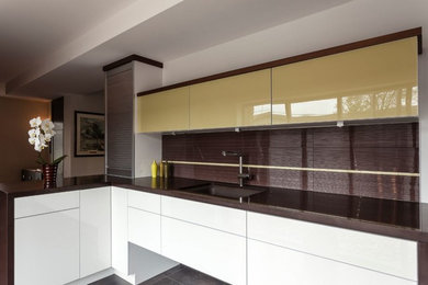 Inspiration for a mid-sized modern l-shaped porcelain tile kitchen remodel in Toronto with an undermount sink, flat-panel cabinets, white cabinets, solid surface countertops, brown backsplash, glass tile backsplash and no island