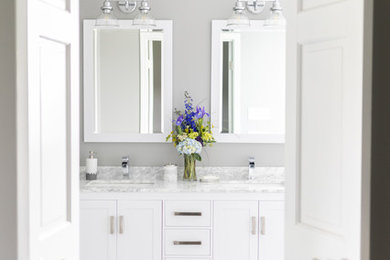 Inspiration for a mid-sized transitional master gray tile and ceramic tile ceramic tile and gray floor bathroom remodel in Chicago with shaker cabinets, yellow cabinets, a two-piece toilet, gray walls, an undermount sink, marble countertops and white countertops