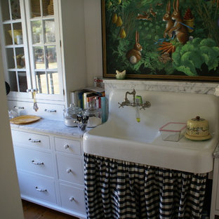 Large farmhouse kitchen pantry ideas - Example of a large country kitchen pantry design in Portland Maine with a farmhouse sink, shaker cabinets, white cabinets, marble countertops, stainless steel appliances and an island