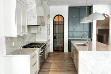 Inspiration for a large transitional l-shaped open concept kitchen remodel in Other with an undermount sink, flat-panel cabinets, beige cabinets, quartzite countertops, beige backsplash, stone slab backsplash, paneled appliances, an island and beige countertops
