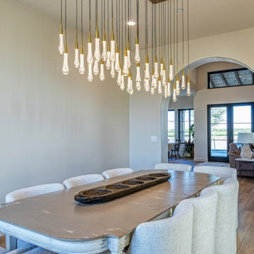Dining Room with Chandelier and View to the Great Room | Tuscan Farmhouse