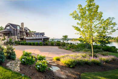 Large mountain style gray three-story wood house exterior photo in Other with a clipped gable roof and a shingle roof