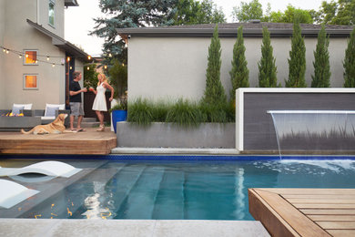 Photo of a small contemporary backyard rectangular pool in Denver with a water feature.