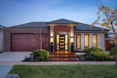 Mid-sized contemporary brown one-story brick house exterior idea in Melbourne with a hip roof and a tile roof