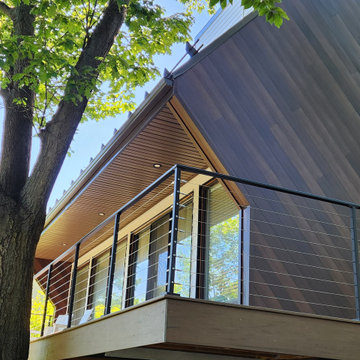 Deck with black metal post cable railing in Quebec, Canada