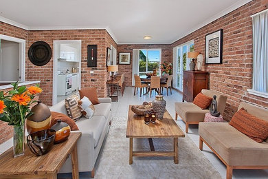 This is an example of a small eclectic family room in Sydney with red walls, ceramic floors, no fireplace and grey floor.