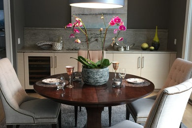 Enclosed dining room - small eclectic light wood floor enclosed dining room idea in Grand Rapids with gray walls