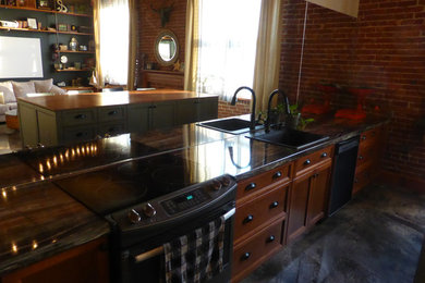 Example of a mid-sized urban galley kitchen design in Montreal with shaker cabinets, laminate countertops and an island