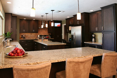 Mid-sized elegant u-shaped open concept kitchen photo in Phoenix with a double-bowl sink, shaker cabinets, dark wood cabinets, granite countertops, stainless steel appliances and a peninsula