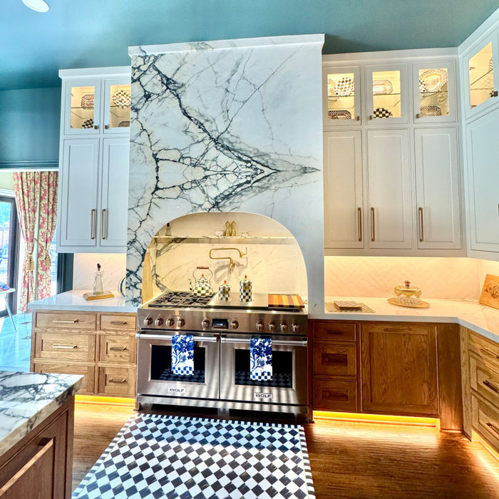 Plano Kitchen Remodeling by Eric cantur Remodeling - check out the accents and features. Marble Vent hood, glass inserts for the top shelves. Kitchen island that matches the marble over the stove.