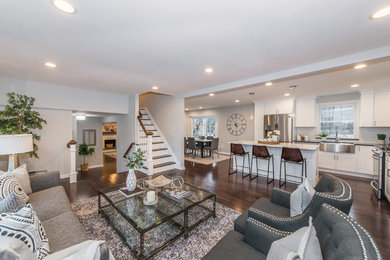 Mid-sized elegant l-shaped dark wood floor and brown floor eat-in kitchen photo in New York with a farmhouse sink, recessed-panel cabinets, white cabinets, quartzite countertops, gray backsplash, subway tile backsplash, stainless steel appliances, an island and white countertops