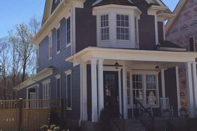 Inspiration for a timeless blue concrete fiberboard gable roof remodel in Other