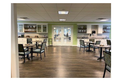 Inspiration for a transitional vinyl floor and brown floor dining room remodel in Indianapolis with green walls