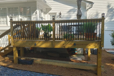 Transitional backyard deck photo in Other