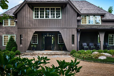 Large rustic brown two-story wood exterior home idea in Charlotte with a hip roof