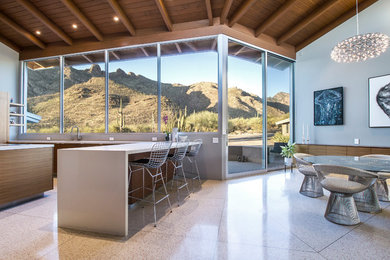 Eat-in kitchen - large modern u-shaped terrazzo floor and white floor eat-in kitchen idea in Phoenix with an undermount sink, flat-panel cabinets, brown cabinets, quartz countertops, paneled appliances and an island