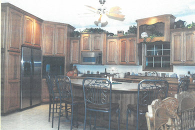 Ceramic tile kitchen photo in Other with recessed-panel cabinets, medium tone wood cabinets and an island