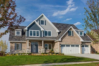 Mid-sized craftsman beige two-story mixed siding exterior home idea in Chicago with a shingle roof