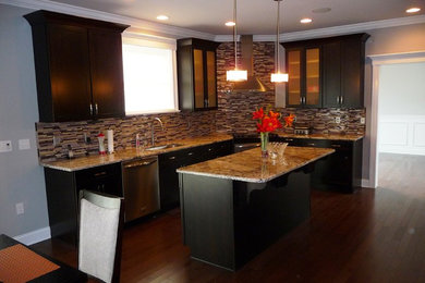 Inspiration for a mid-sized timeless l-shaped medium tone wood floor eat-in kitchen remodel in Philadelphia with an undermount sink, shaker cabinets, black cabinets, quartz countertops, multicolored backsplash, glass tile backsplash, stainless steel appliances and an island