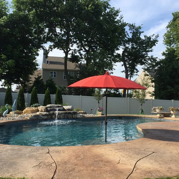 Forks Township custom pool with sunshelf & rock waterfall