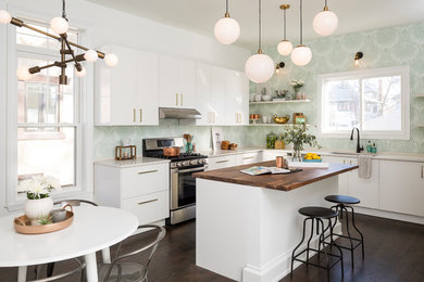 Inspiration for a contemporary l-shaped dark wood floor and brown floor kitchen remodel in Chicago with an undermount sink, flat-panel cabinets, white cabinets, wood countertops, stainless steel appliances and an island