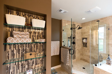 Large traditional master bathroom in DC Metro with a drop-in tub, a corner shower, brown tile, stone tile, brown walls, medium hardwood floors, brown floor and a hinged shower door.