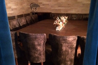 Photo of a medium sized rustic open plan dining room in Other with brown walls, concrete flooring and no fireplace.