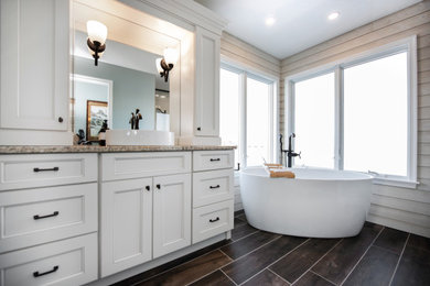 Example of a mid-sized beach style master beige tile and porcelain tile single-sink, porcelain tile, brown floor and shiplap wall bathroom design in Philadelphia with shaker cabinets, white cabinets, granite countertops, a hinged shower door, multicolored countertops, a built-in vanity, white walls and a vessel sink