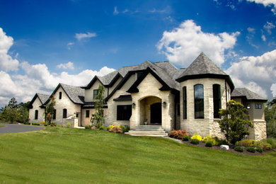 Large traditional beige exterior home idea in St Louis