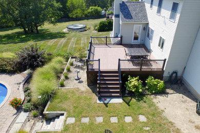 Deck - mid-sized contemporary backyard ground level metal railing deck idea in New York with no cover