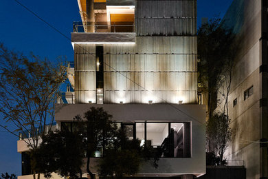 Contemporary three-story concrete flat roof idea in Other