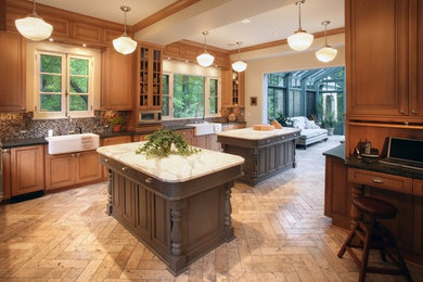 Elegant kitchen photo in Milwaukee with mosaic tile backsplash, a farmhouse sink and marble countertops