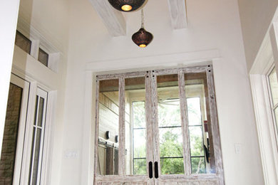 Inspiration for a mid-sized contemporary foyer in Denver with white walls, marble floors and a double front door.