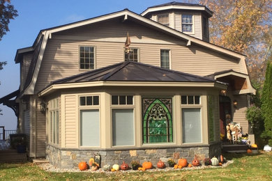 Example of a mid-sized terra-cotta tile sunroom design in Burlington with a wood stove and a standard ceiling