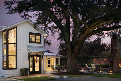 Example of a mid-sized transitional white one-story wood house exterior design in Birmingham with a metal roof