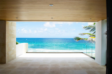 Balcony - huge contemporary balcony idea in Miami with a roof extension