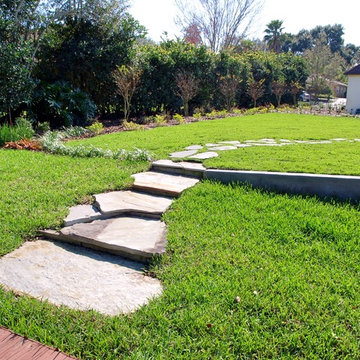 Tudor Revival backyard lakefront landscape design